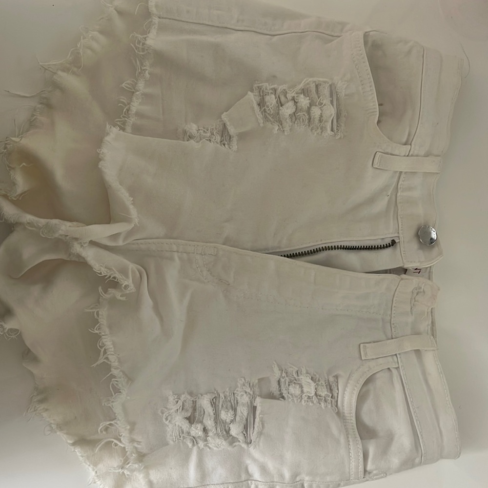 white jean shorts with rips